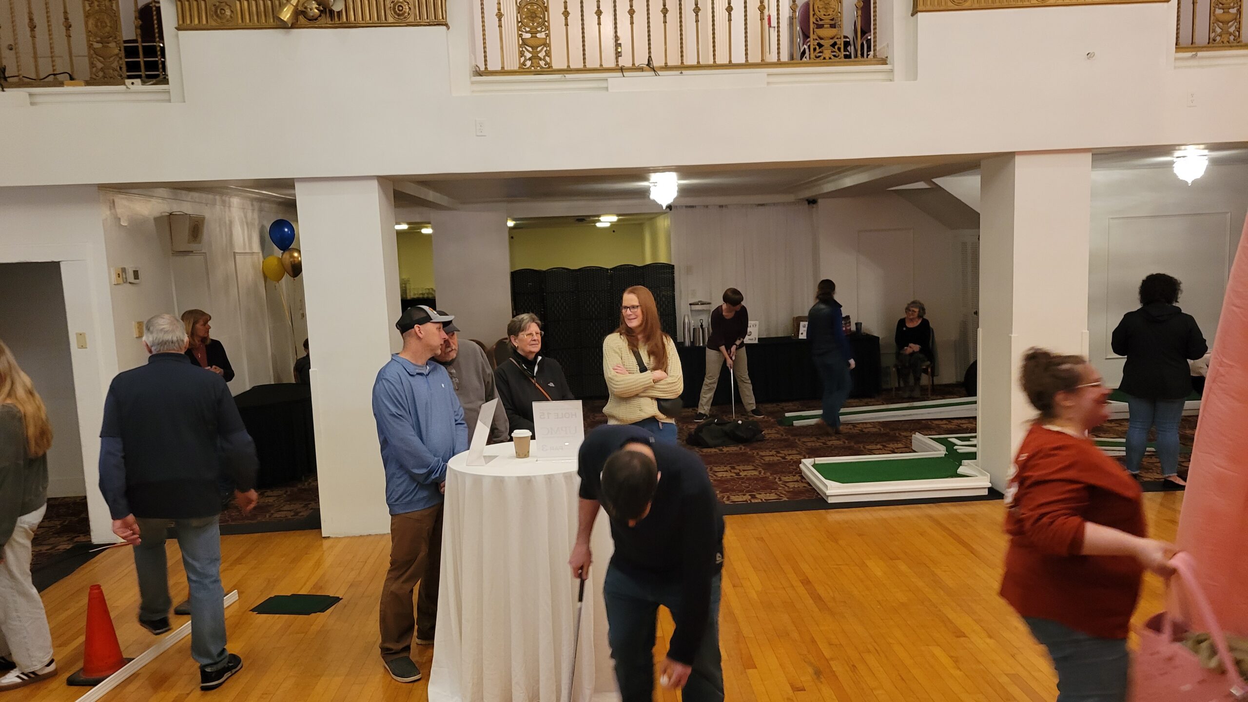 Family and friends chatting while watching others golf