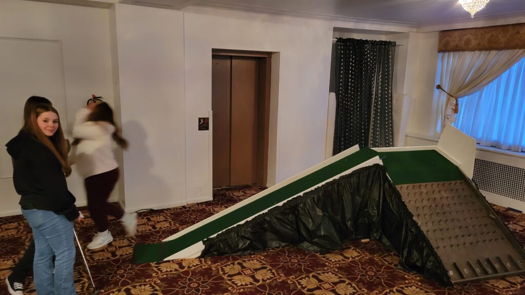 People trying to golf on a steep course