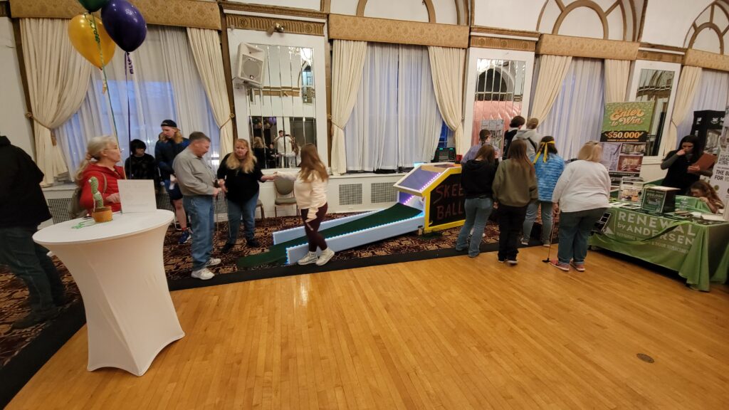 A family golfing and others socializing
