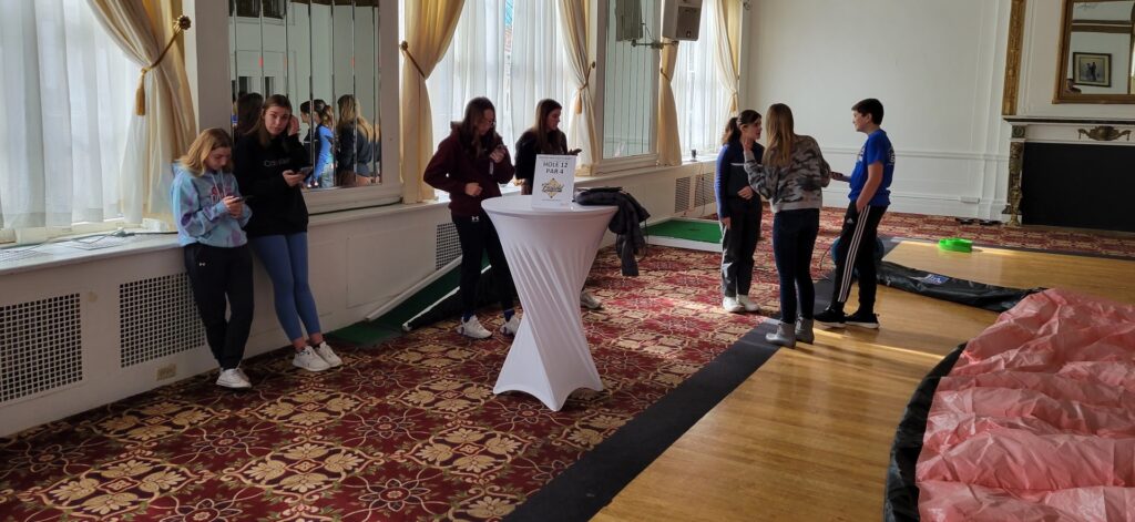 Young people golfing together