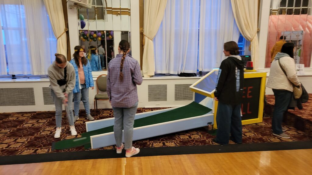People trying out the Skee-ball golf course