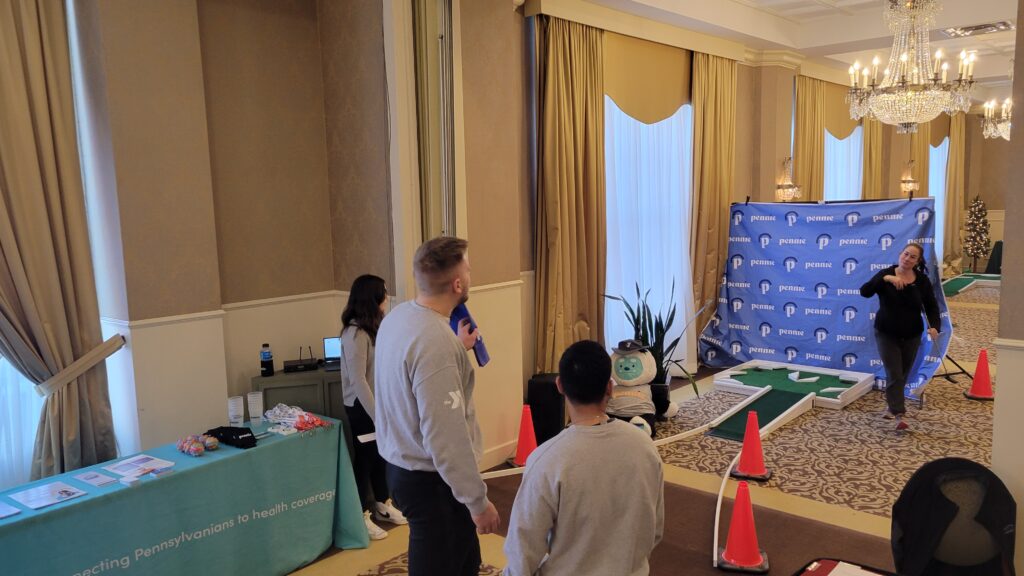 A sponsor talking and golfing with others