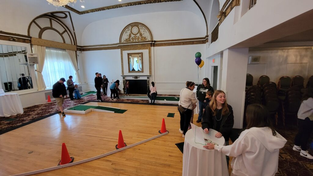 People socializing and golfing